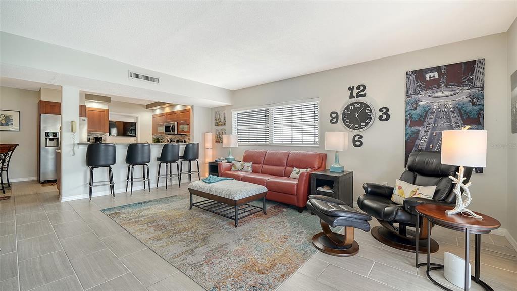 225 Hour Glass Way, Unit 202 Sarasota, FL 34242 - Photo 21 of 68 a living room with furniture and wooden floor