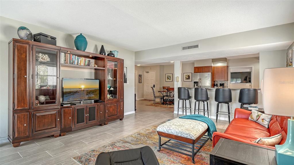 225 Hour Glass Way, Unit 202 Sarasota, FL 34242 - Photo 22 of 68 a living room with furniture and a flat screen tv