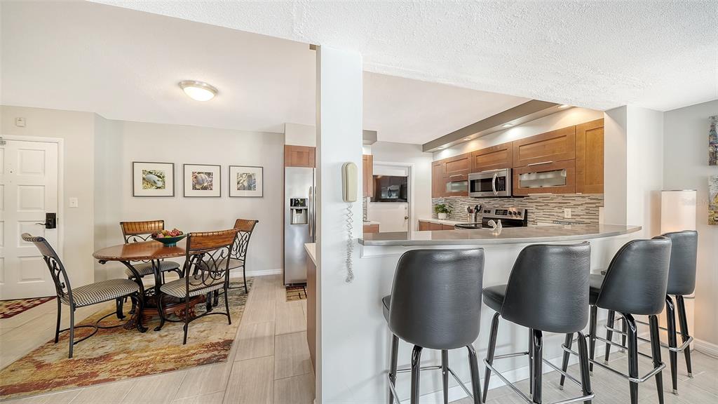 225 Hour Glass Way, Unit 202 Sarasota, FL 34242 - Photo 23 of 68 a large kitchen with a table and chairs