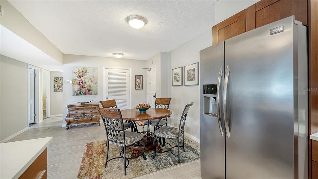 225 Hour Glass Way, Unit 202 Sarasota, FL 34242 - Photo 26 of 68 a dining room with furniture and wooden floor