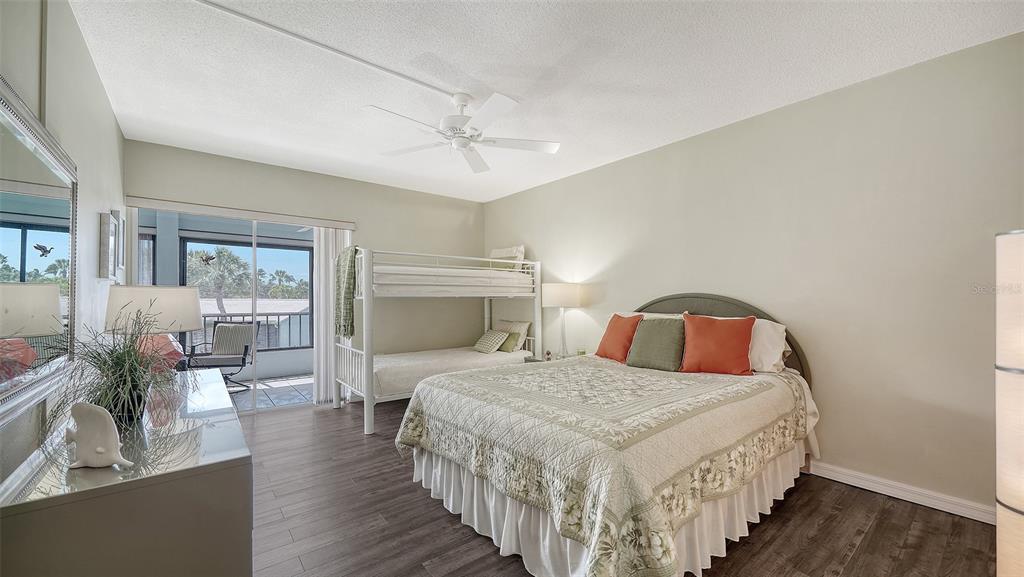 225 Hour Glass Way, Unit 202 Sarasota, FL 34242 - Photo 27 of 68 a bedroom with bed and wooden floor