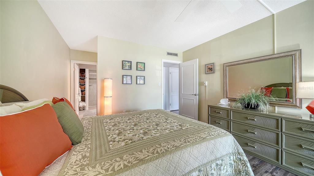 225 Hour Glass Way, Unit 202 Sarasota, FL 34242 - Photo 28 of 68 a bedroom with a bed and a dresser in it