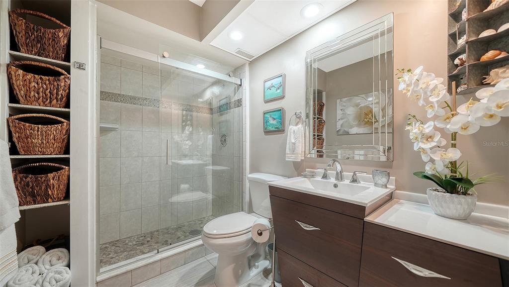 225 Hour Glass Way, Unit 202 Sarasota, FL 34242 - Photo 30 of 68 a bathroom with a sink a toilet and shower