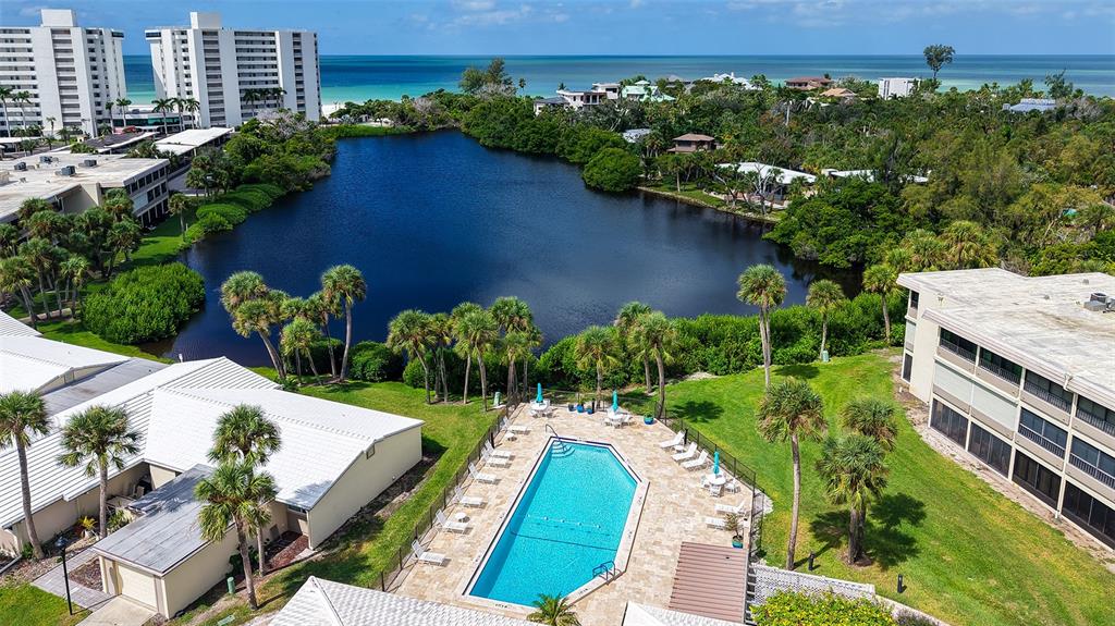 225 Hour Glass Way, Unit 202 Sarasota, FL 34242 - Photo 39 of 68 an aerial view of a house with a yard and lake view