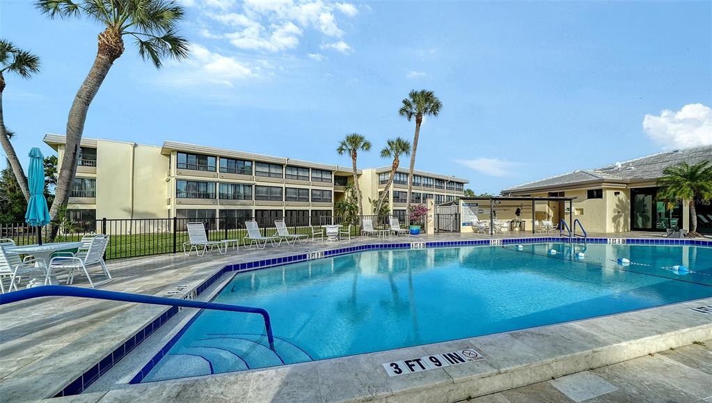 225 Hour Glass Way, Unit 202 Sarasota, FL 34242 - Photo 41 of 68 a view of a swimming pool with a patio