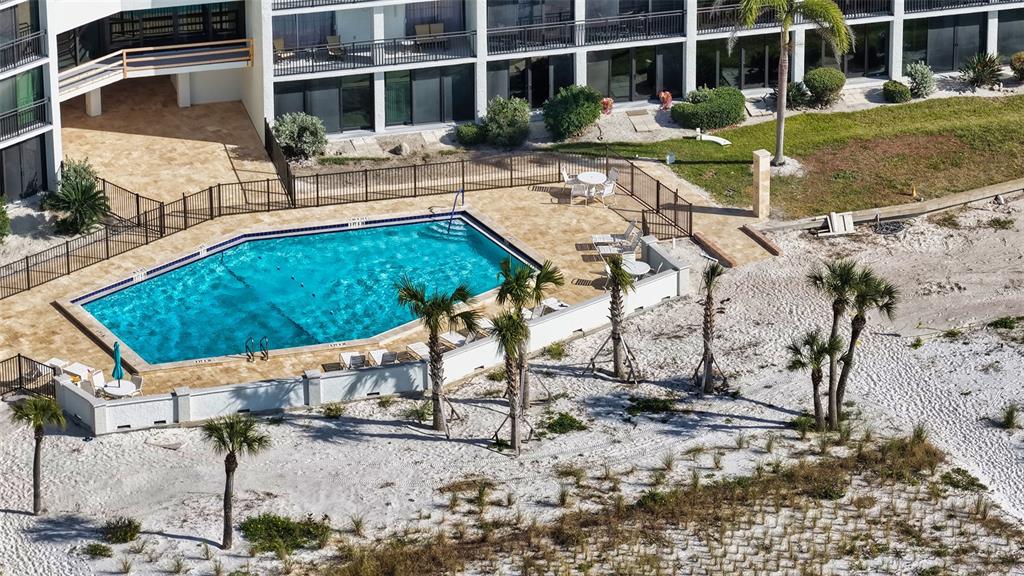 225 Hour Glass Way, Unit 202 Sarasota, FL 34242 - Photo 46 of 68 a view of a swimming pool with a lounge chairs