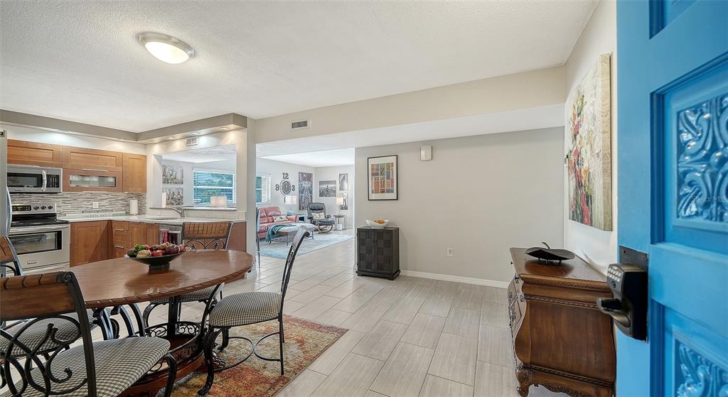 225 Hour Glass Way, Unit 202 Sarasota, FL 34242 - Photo 5 of 68 a dining room with furniture and wooden floor