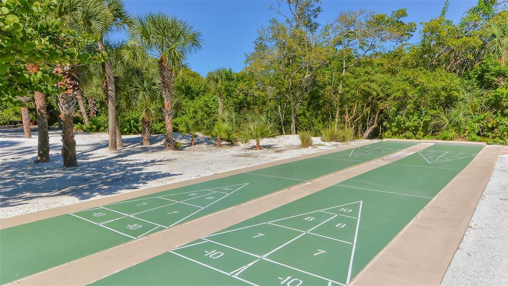 225 Hour Glass Way, Unit 202 Sarasota, FL 34242 - Photo 58 of 68 a view of a tennis ground with large trees