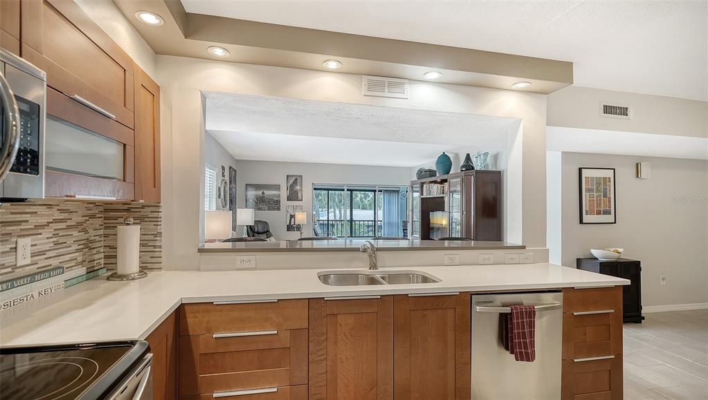 225 Hour Glass Way, Unit 202 Sarasota, FL 34242 - Photo 10 of 68 a view of a double sink and a refrigerator