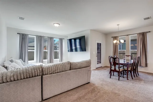 a living room with furniture and large windows