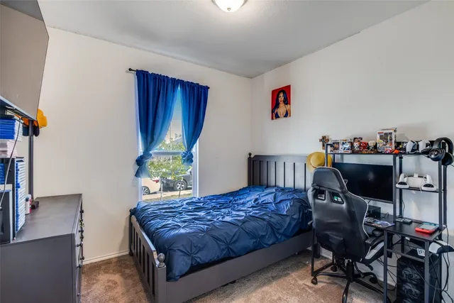 a bedroom with a bed and a table in it