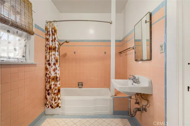 a bathroom with a sink a mirror and a shower