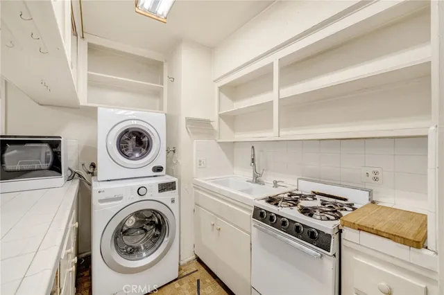 a view of a storage and utility room with washer and dryer
