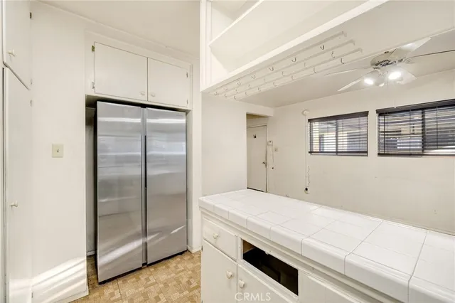 a kitchen with a refrigerator and countertop