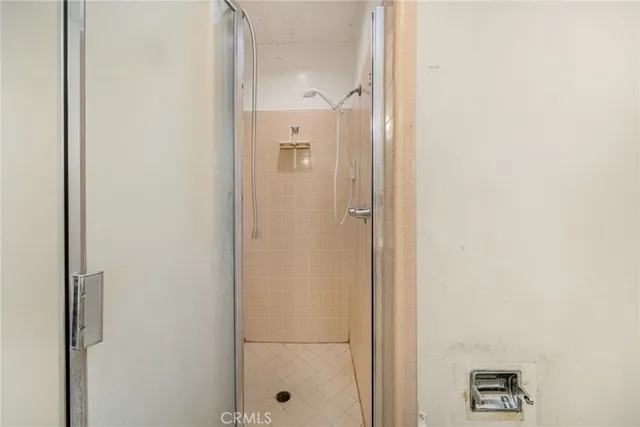 a bathroom with a glass shower door