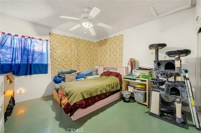 a spacious bedroom with a bed and a chandelier