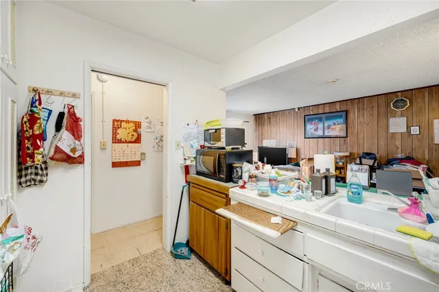a view of a kitchen with fridge and window