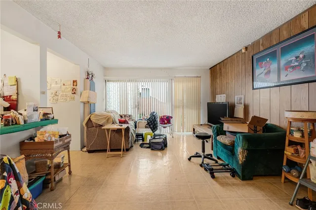 a view of a livingroom with workspace and a window