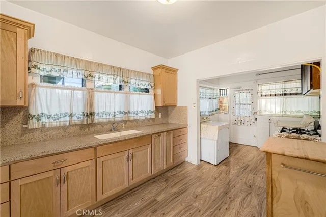 a kitchen with a sink stove and wooden cabinets