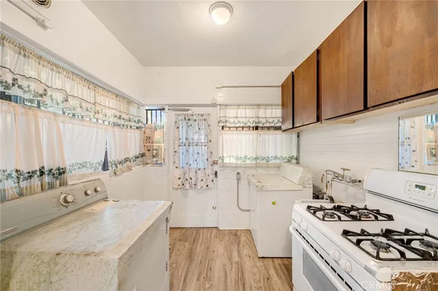 a kitchen with stainless steel appliances granite countertop a stove and a sink