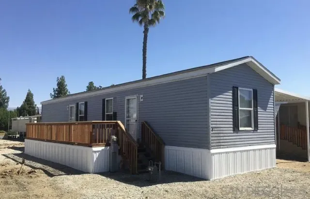 a view of a house with roof deck and furniture