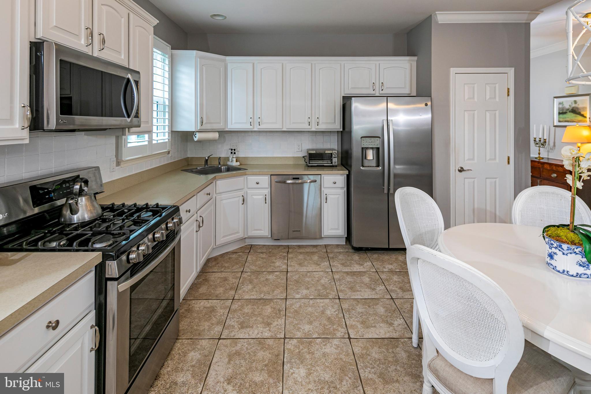 24 Foster Road Pennington, NJ 08534 - Photo 13 of 38 a kitchen with a stove a sink and a microwave