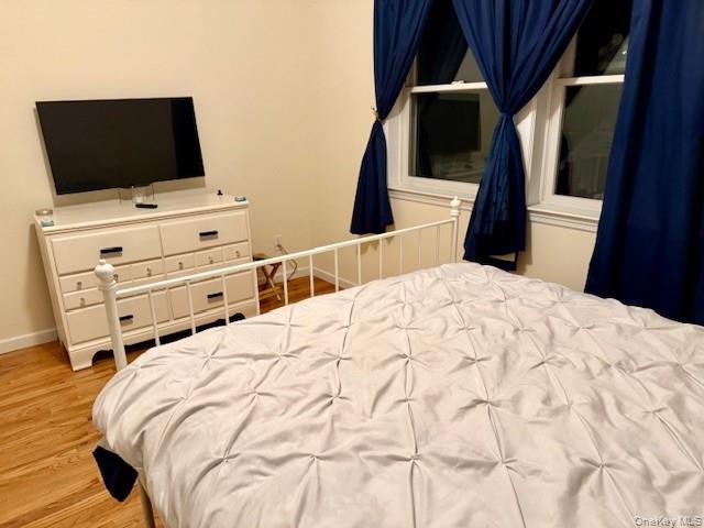120 East 6th Road Queens, NY 11693 - Photo 11 of 22 a bedroom with a bed and flat screen tv