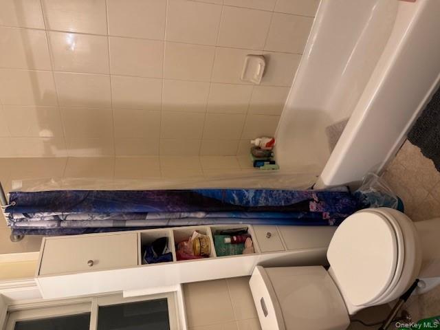 120 East 6th Road Queens, NY 11693 - Photo 13 of 20 a white toilet sitting next to a bath tub