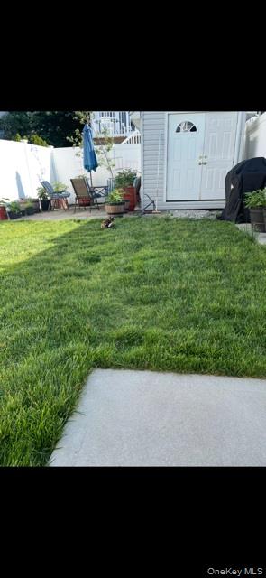 120 East 6th Road Queens, NY 11693 - Photo 18 of 20 a view of yard with car parked