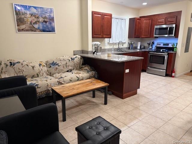120 East 6th Road Queens, NY 11693 - Photo 2 of 20 a kitchen with stainless steel appliances granite countertop a sink a stove a refrigerator and a cabinets