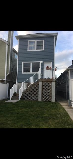 120 East 6th Road Queens, NY 11693 - Photo 21 of 22 a front view of a house with a yard
