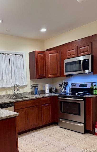 120 East 6th Road Queens, NY 11693 - Photo 6 of 22 a kitchen with stainless steel appliances granite countertop a stove a sink dishwasher and a microwave oven on the wooden floor