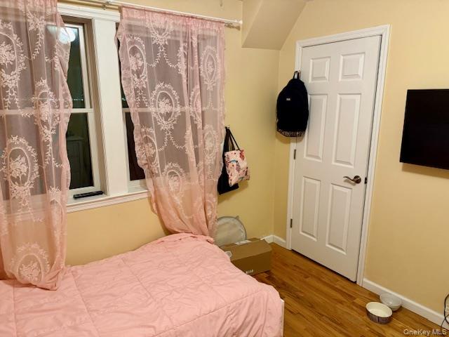 120 East 6th Road Queens, NY 11693 - Photo 9 of 22 a bedroom with a bed and a flat tv screen on the dresser