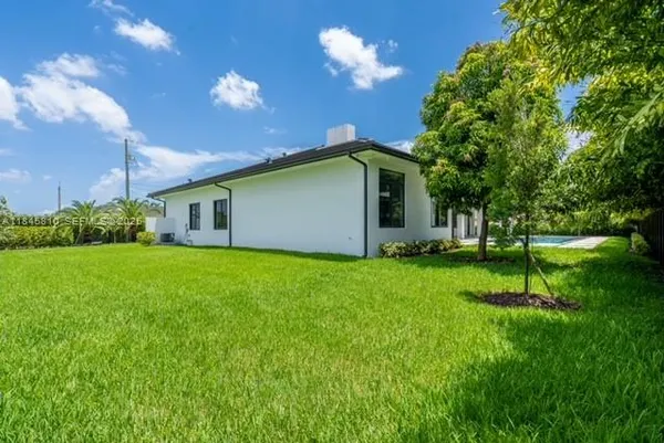 a kitchen with kitchen island a counter top a sink stainless steel appliances and cabinets