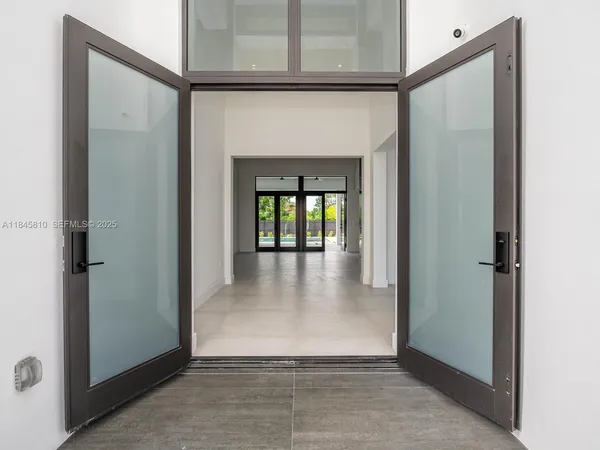 a kitchen with cabinets and a refrigerator
