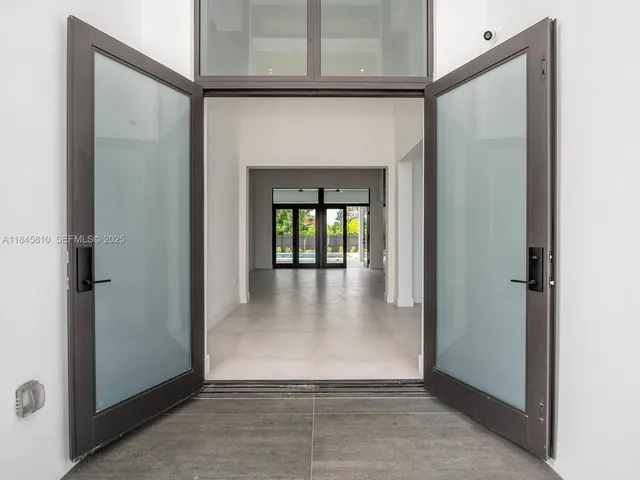 a kitchen with cabinets and a refrigerator