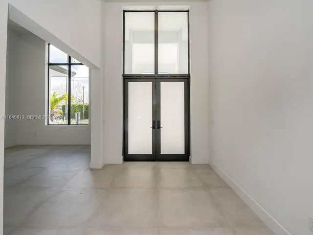 a view of empty room with large windows