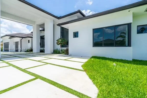 a front view of house with yard and green space