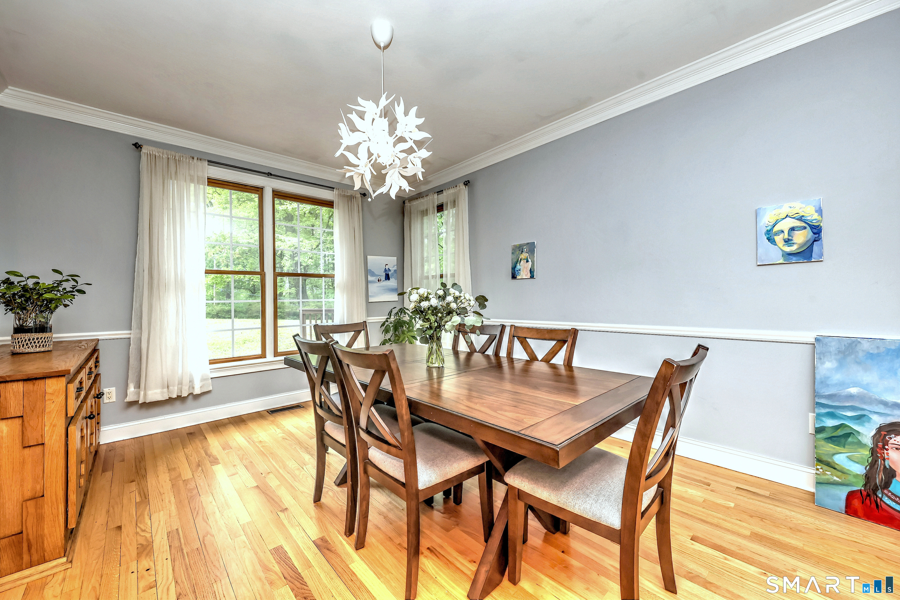 125 Peck Hill Road Woodbridge, CT 06525 - Photo 8 of 40 a view of a dining room with furniture a chandelier and wooden floor
