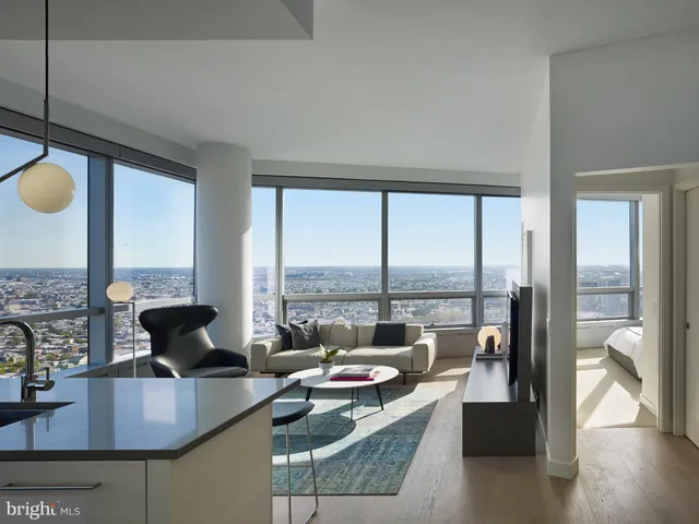 a living room with couches chairs and a large window
