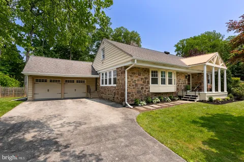 a view of a house with a yard patio and sitting area