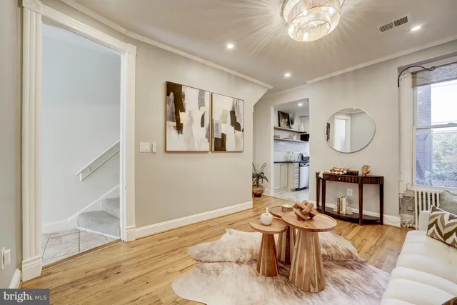 a living room with furniture a mirror and a window