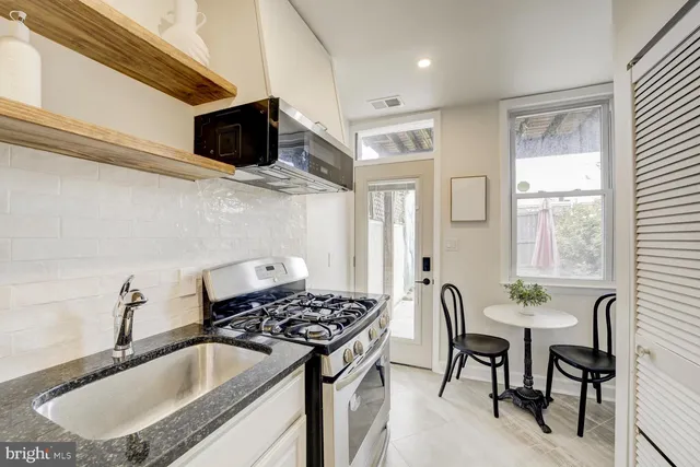 a kitchen that has a sink and a stove