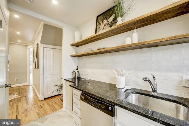 a kitchen with a sink and a refrigerator