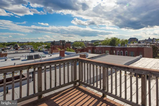 a view of a balcony with wooden fence