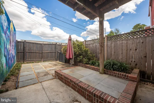 a view of a house with sitting area and garden