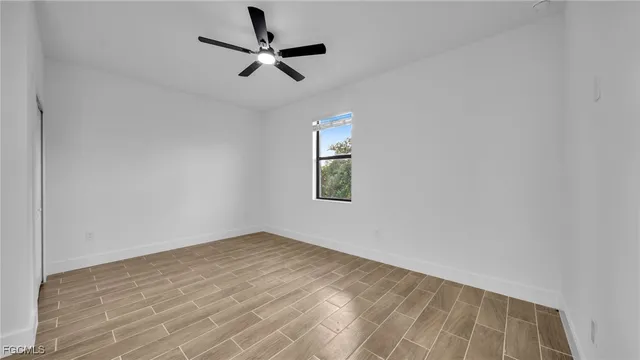 a view of a room with a stylish ceiling fan and entryway