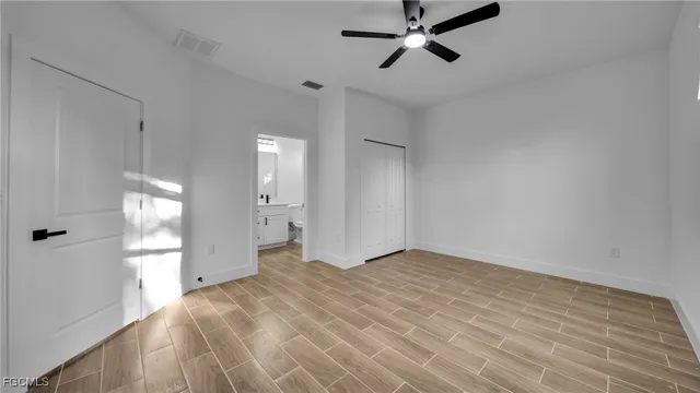 a view of an empty room with a ceiling fan