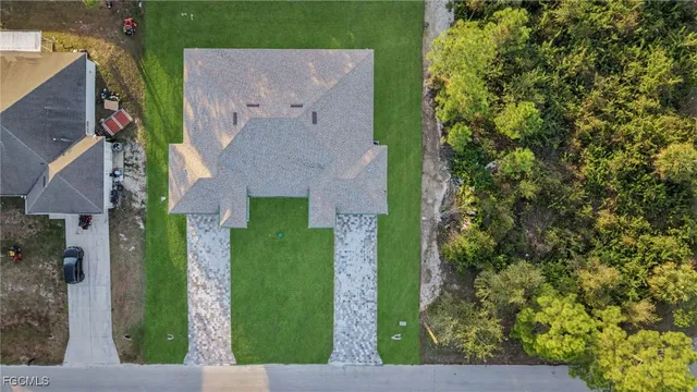 a aerial view of a house next to a yard