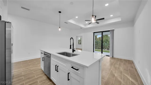 a kitchen with stainless steel appliances a sink and a refrigerator